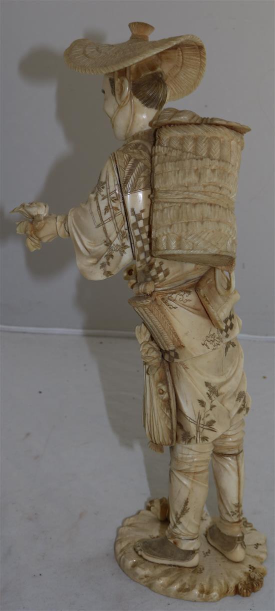 A large Japanese sectional ivory figure of a farmer, early 20th century, 36.5cm